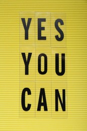 Photo of Phrase Yes You Can with of plastic letters on yellow background, top view. Motivational quote