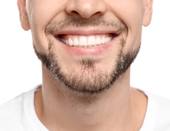 Photo of Young man with beautiful smile on white background. Teeth whitening