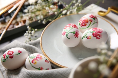 Photo of Beautifully painted Easter eggs on table, closeup