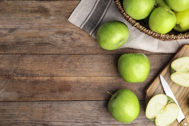 Photo of Flat lay composition of fresh ripe green apples on wooden table, space for text