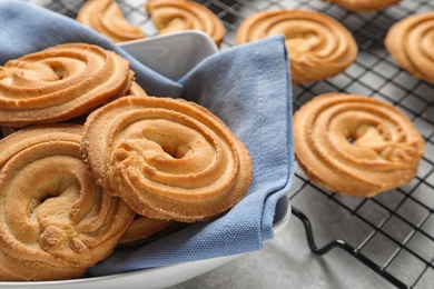 Composition with bowl of Danish butter cookies on table, closeup