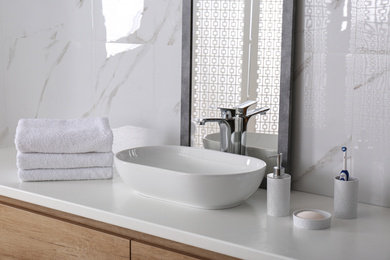 Photo of Modern mirror and vessel sink in stylish bathroom