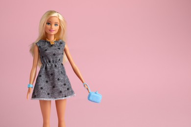 Photo of Mykolaiv, Ukraine - September 2, 2023: Beautiful Barbie doll with bag on pale pink background, space for text