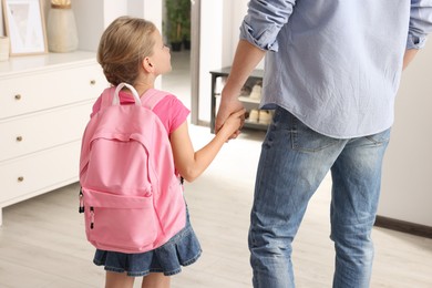 Little girl with father at home. Ready to go to school