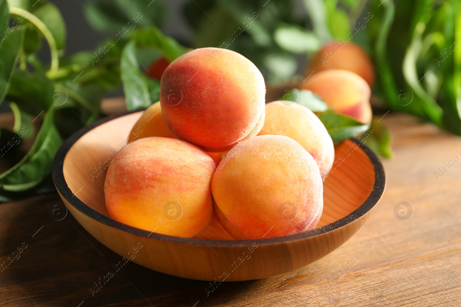 Photo of Plate with fresh sweet ripe peaches on table