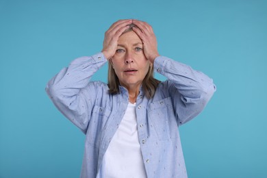 Photo of Portrait of surprised senior woman on light blue background