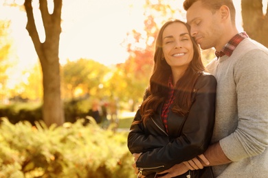 Happy couple in sunny park. Autumn walk