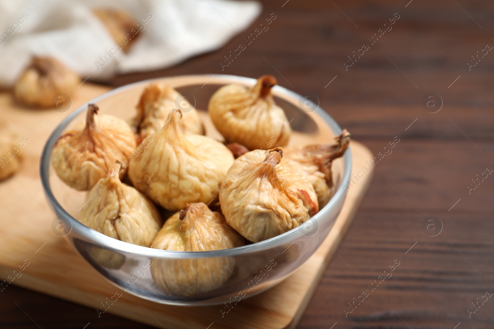 Photo of Tasty dried figs on wooden table, closeup