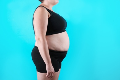 Photo of Fat woman on color background, space for text. Weight loss