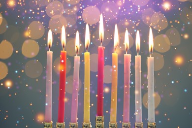 Image of Hanukkah celebration. Menorah with burning candles against blurred lights, closeup