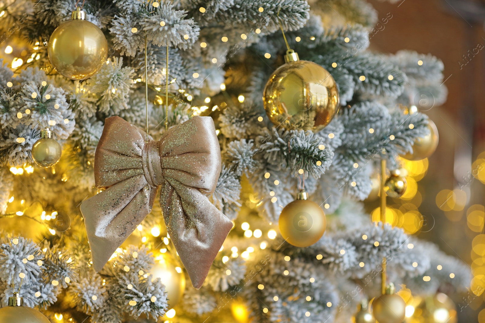 Photo of Beautiful decorated Christmas tree with baubles and lights on blurred background, closeup