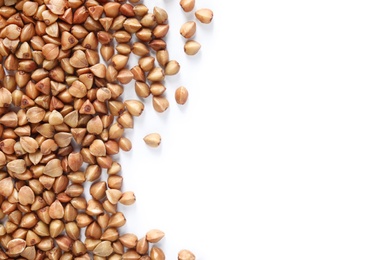 Photo of Uncooked buckwheat on white background, top view