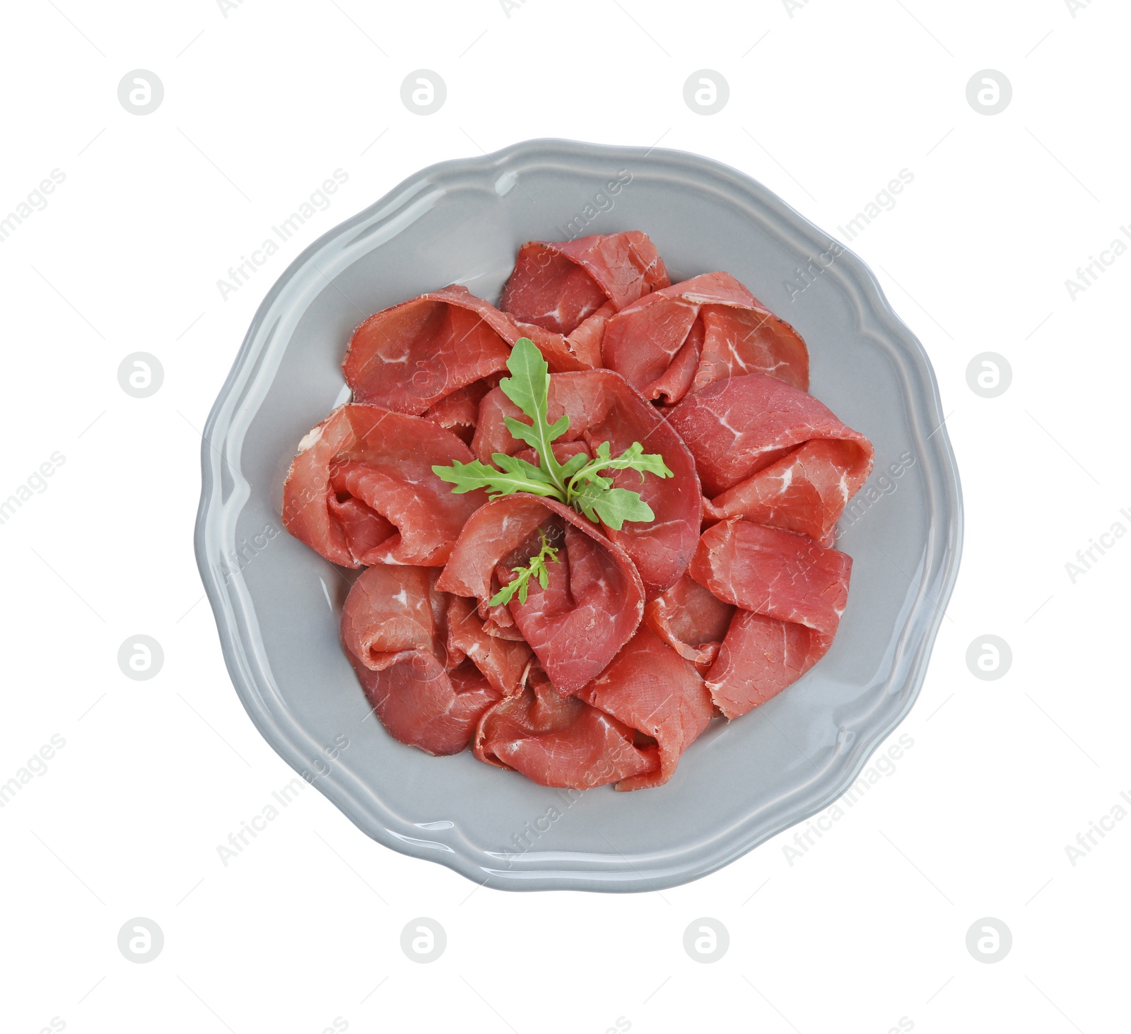 Photo of Slices of tasty fresh dry bresaola and arugula isolated on white, top view