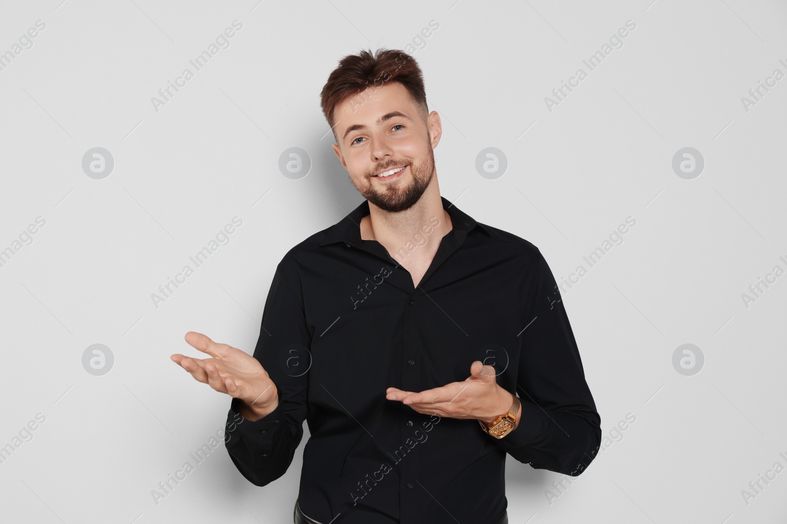 Photo of Handsome man in black shirt on light grey background