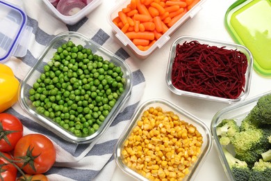 Containers with fresh products on white table, flat lay. Food storage