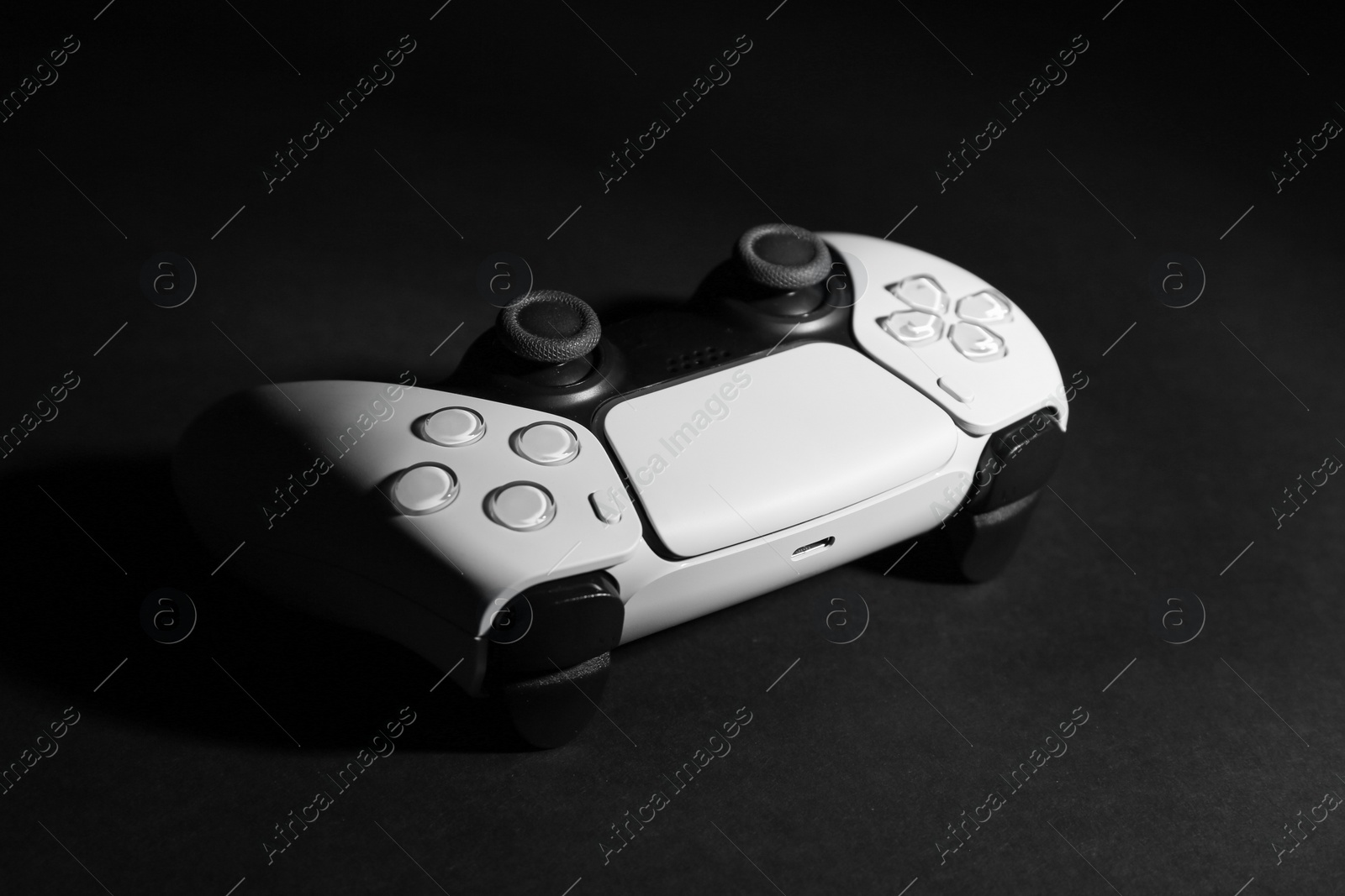 Photo of One wireless game controller on black background