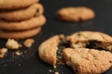 Photo of Delicious cookie with raisins on black table, closeup