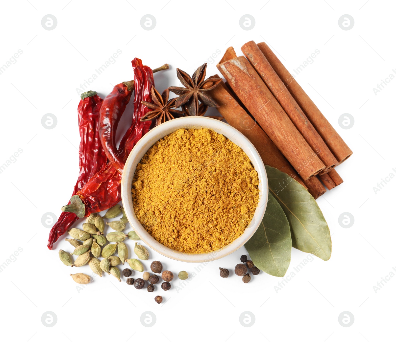 Photo of Curry powder in bowl and other spices isolated on white, top view