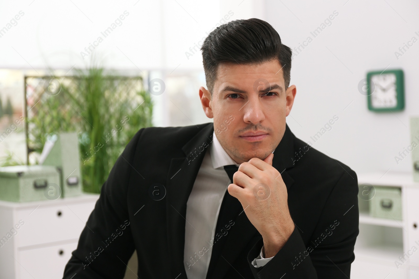 Photo of Business trainer in suit holding online webinar indoors, view from webcam