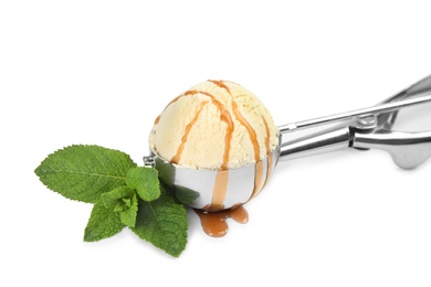 Photo of Delicious ice cream with caramel sauce in scoop and mint on white background