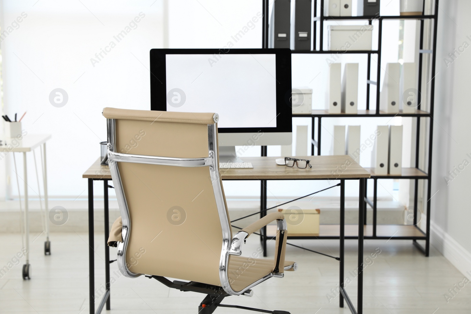 Photo of Modern workplace with comfortable chair in stylish office interior