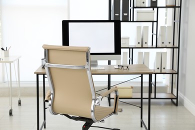 Modern workplace with comfortable chair in stylish office interior