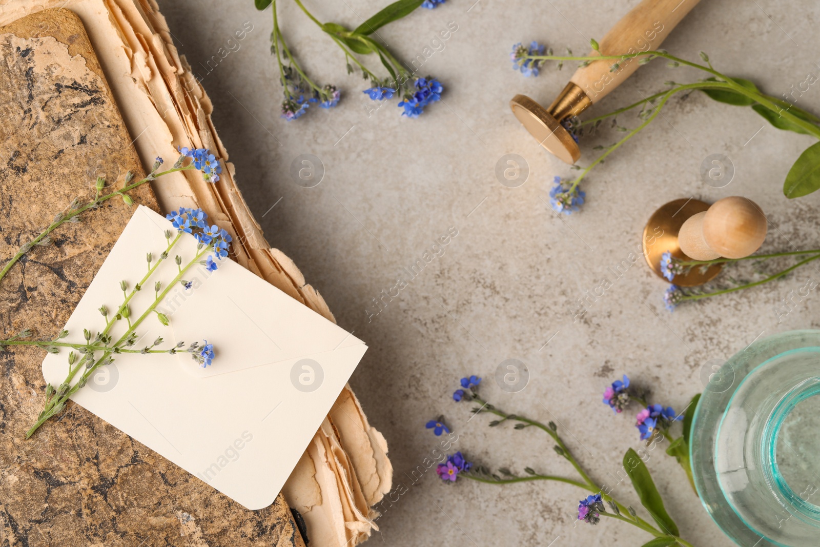 Photo of Flat lay composition with beautiful Forget-me-not flowers on grey table