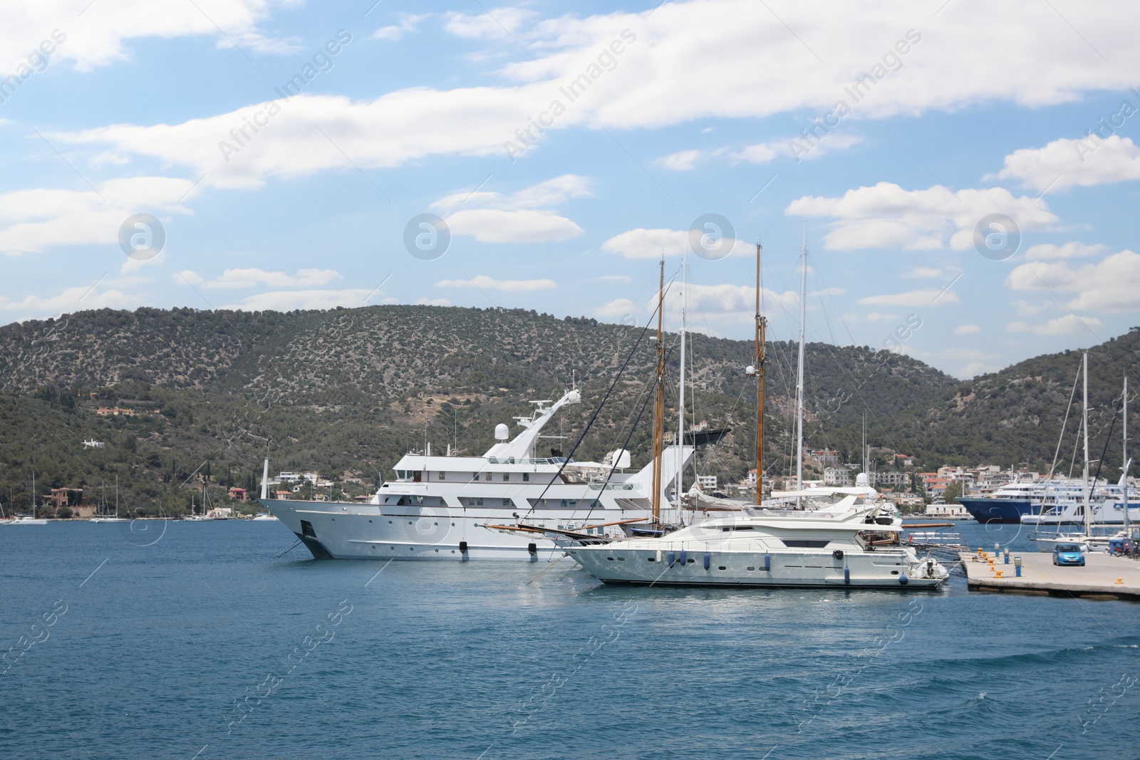 Photo of Beautiful view of different boats in sea near shore on sunny day