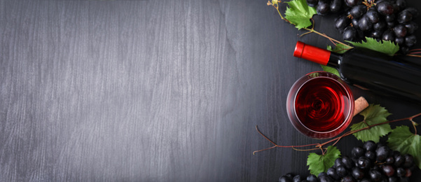 Image of Flat lay composition with fresh ripe juicy grapes and wine on wooden background, space for text. Banner design