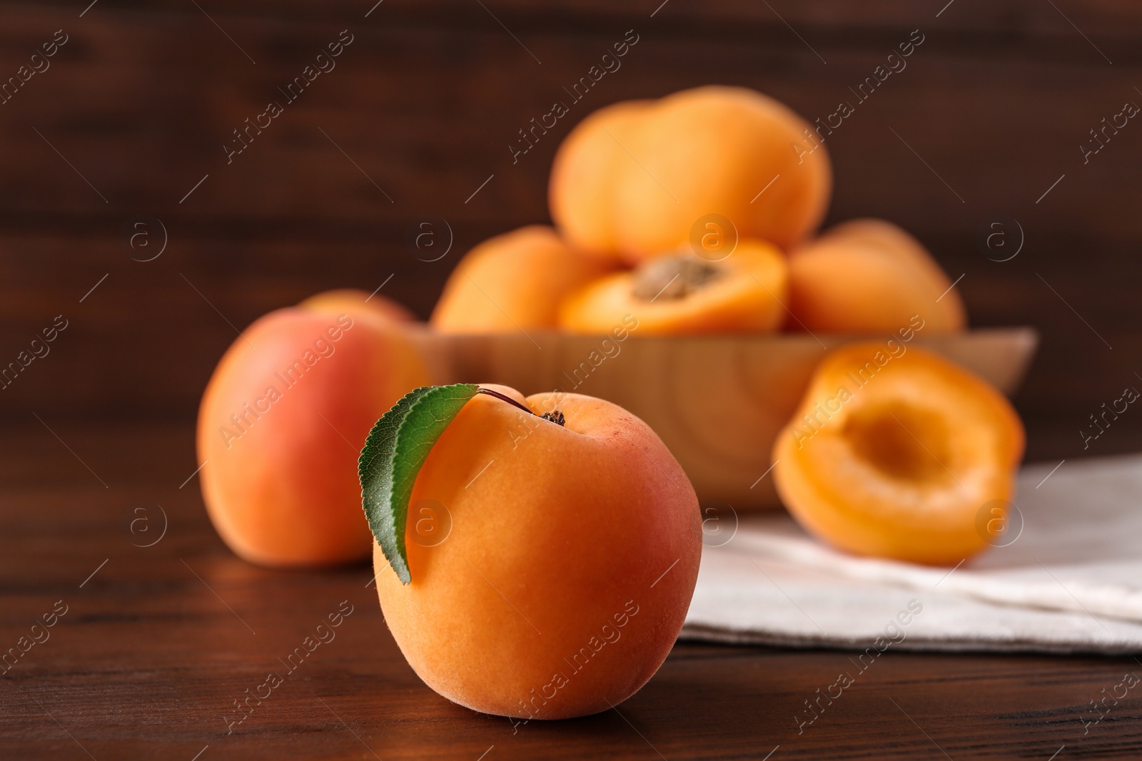 Photo of Delicious ripe sweet apricot on wooden table, closeup