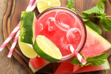 Photo of Delicious fresh watermelon drink on wooden table, top view