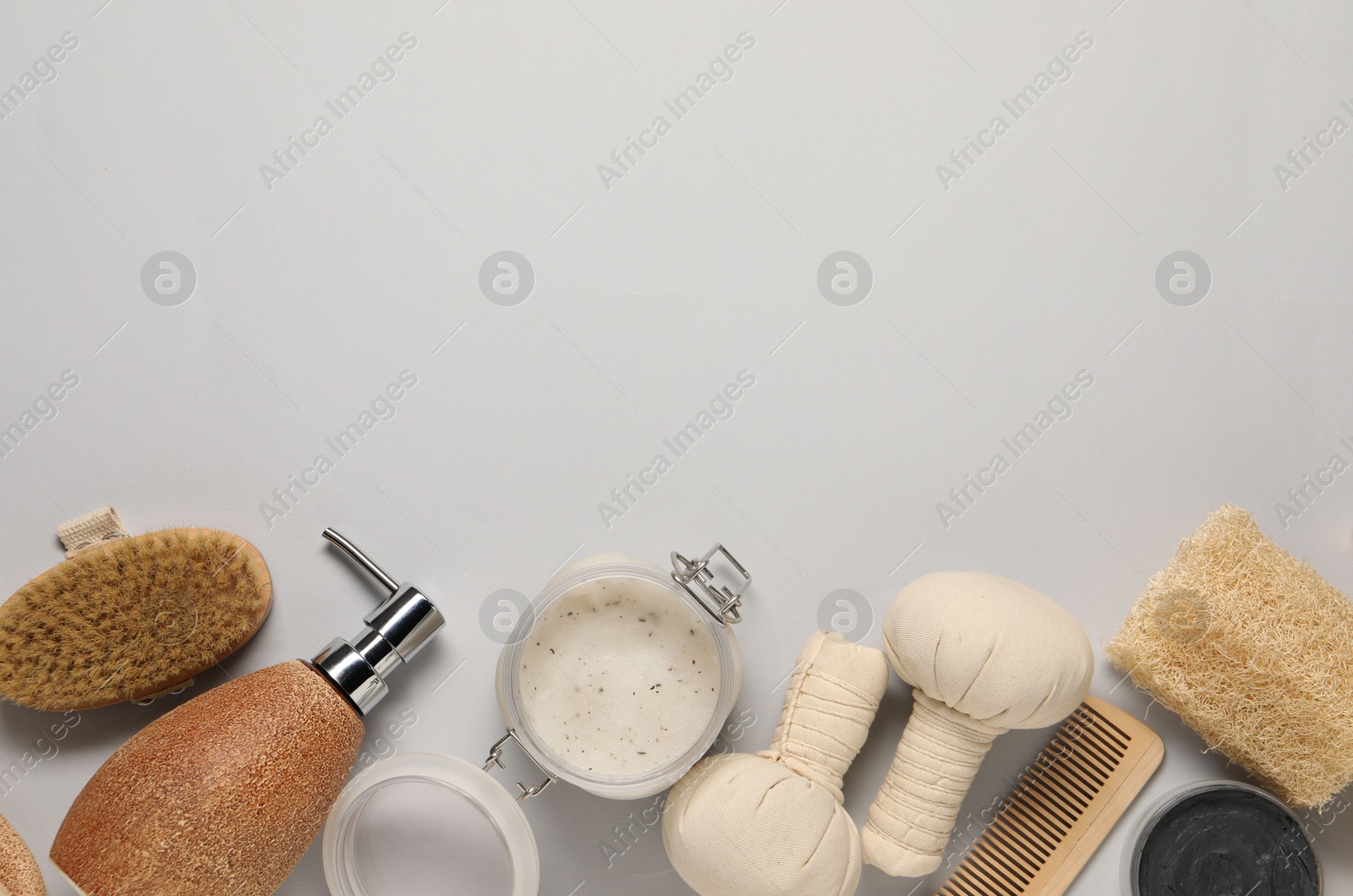 Photo of Bath accessories. Flat lay composition with personal care products on light grey background, space for text