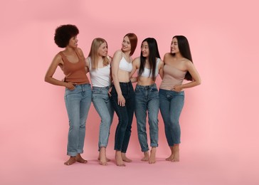 Group of beautiful young women on pink background