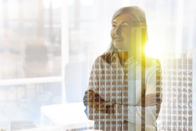 Image of Double exposure of successful businesswoman and cityscape