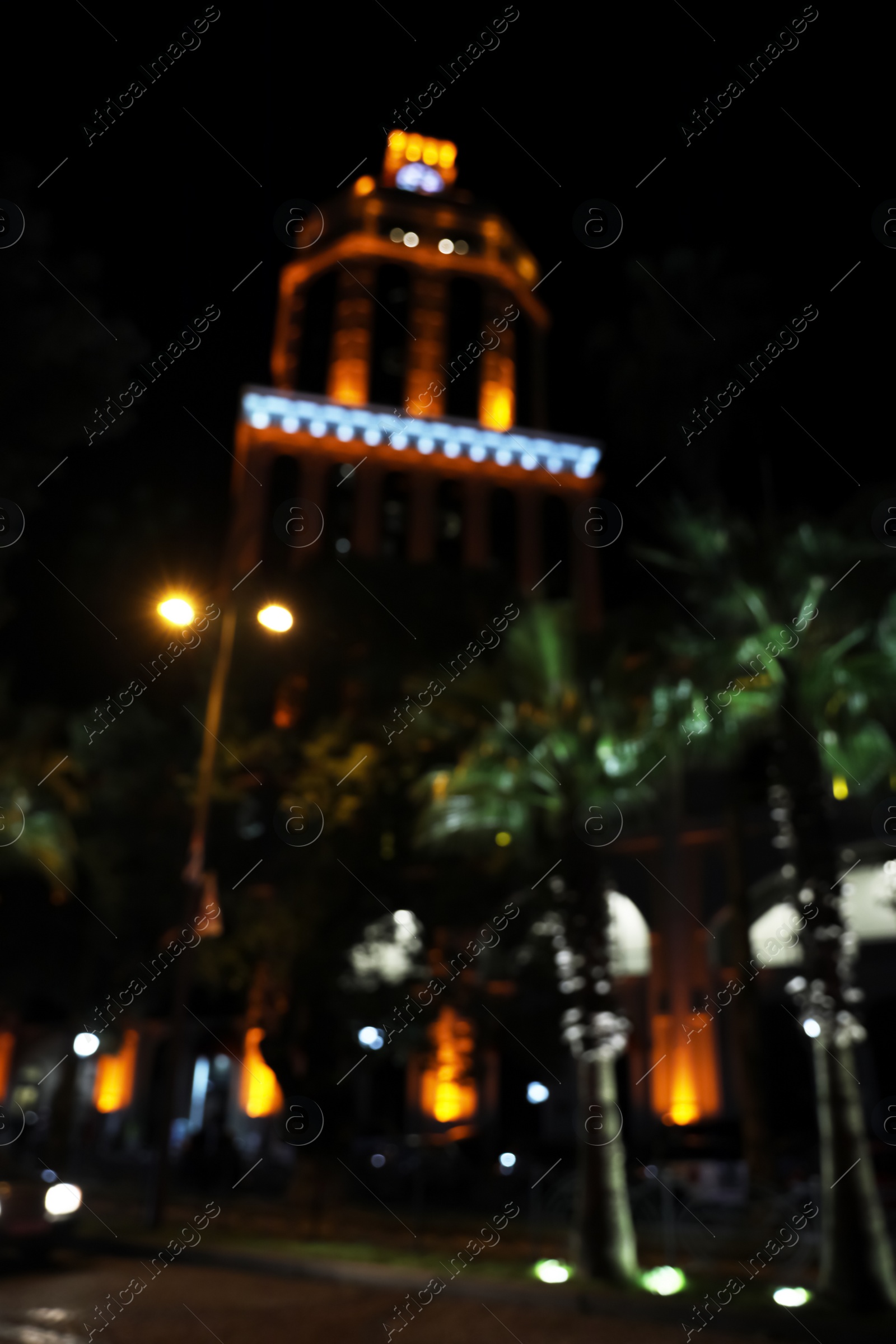 Photo of Blurred view of city street with lights at night. Bokeh effect