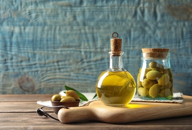 Composition with fresh olive oil on table