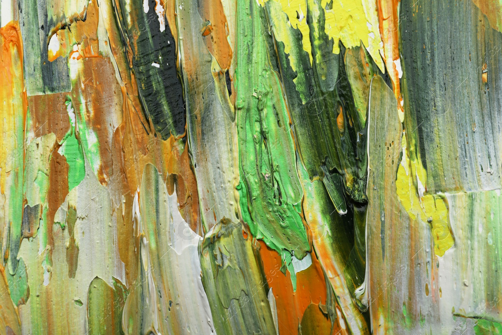 Photo of Beautiful strokes of colorful oil paints as background, closeup