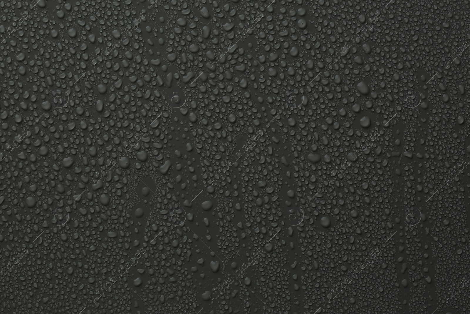 Photo of Many water drops on dark grey background