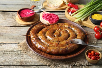 Tasty homemade sausages served on wooden table