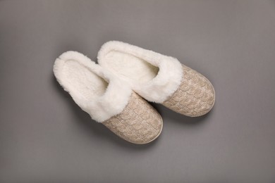 Photo of Pair of beautiful soft slippers on grey background, top view
