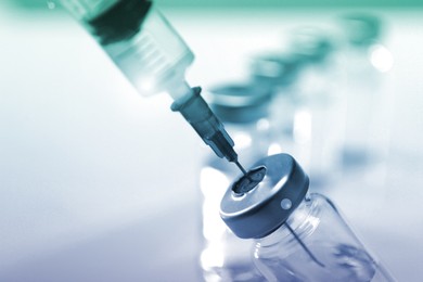 Image of Filling syringe with medicine from vial, closeup