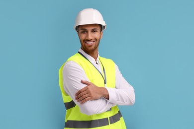 Engineer in hard hat on light blue background