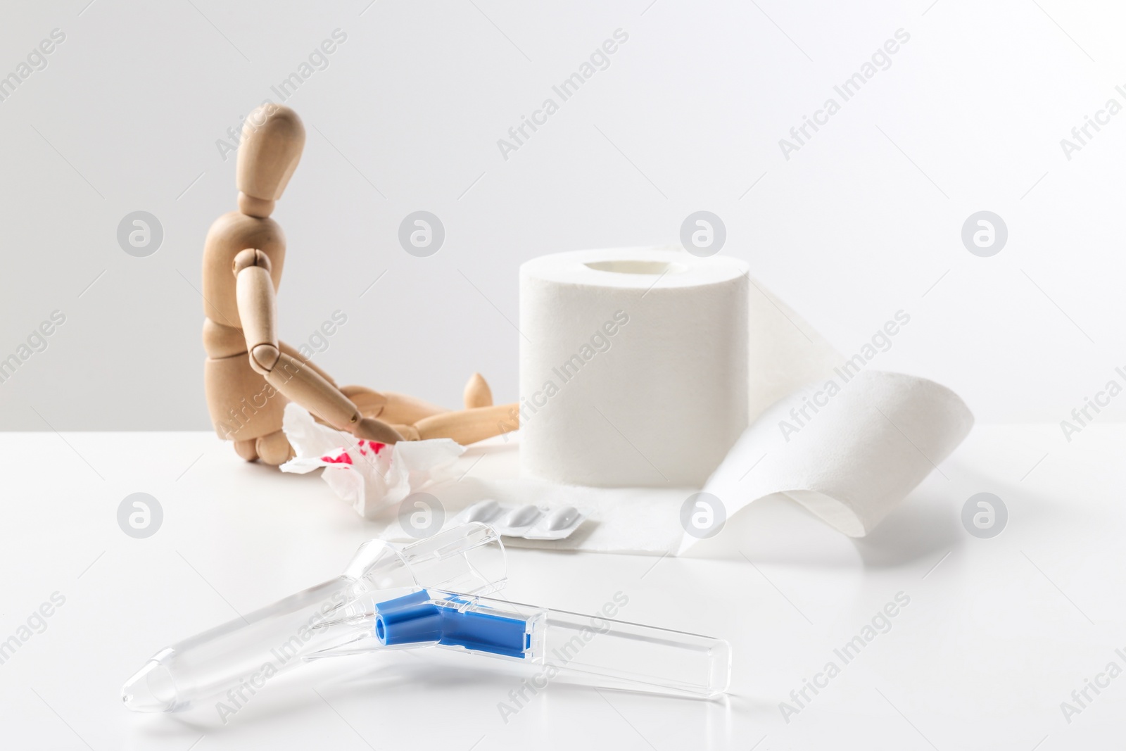 Photo of Composition with anoscope on white background. Hemorrhoid treatment