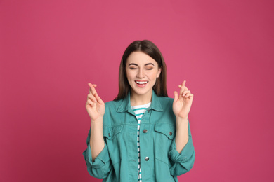 Photo of Portrait of happy young woman on pink background