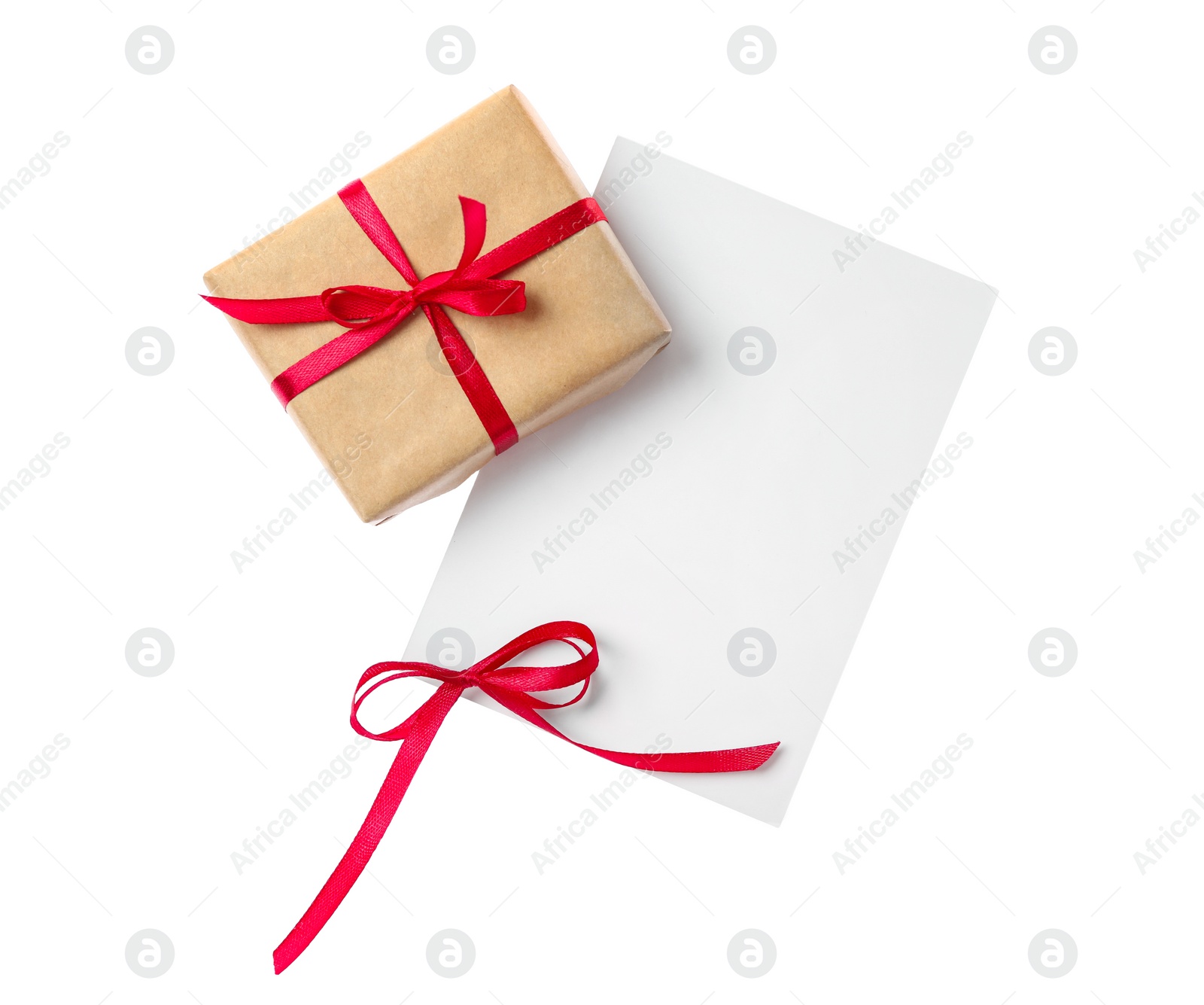 Photo of Blank card with red bow and gift box on white background, top view. Valentine's Day celebration