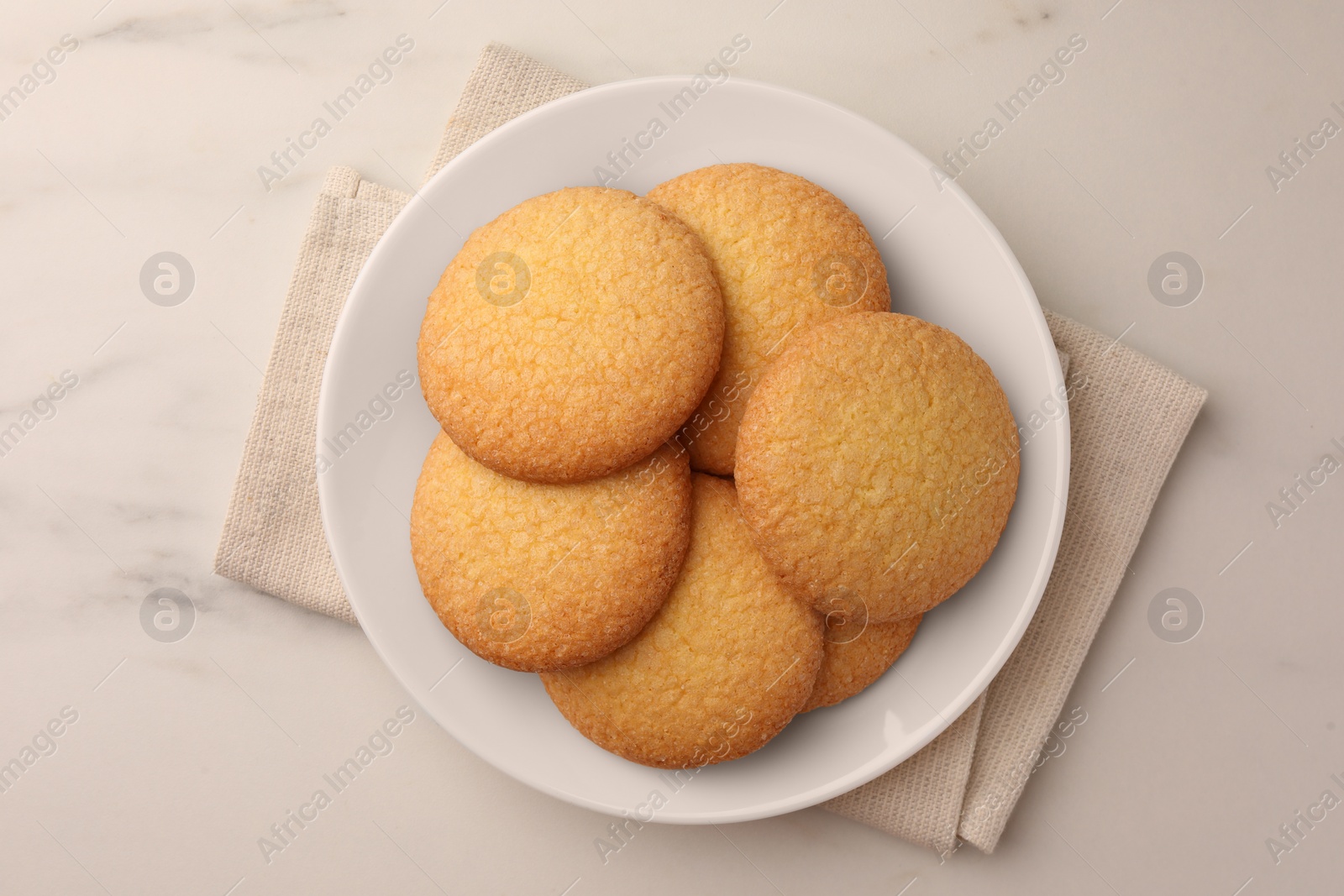 Photo of Delicious Danish butter cookies on white marble table, top view