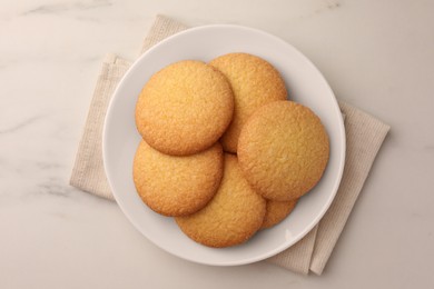 Photo of Delicious Danish butter cookies on white marble table, top view