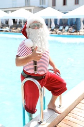 Photo of Authentic Santa Claus getting out of pool at resort