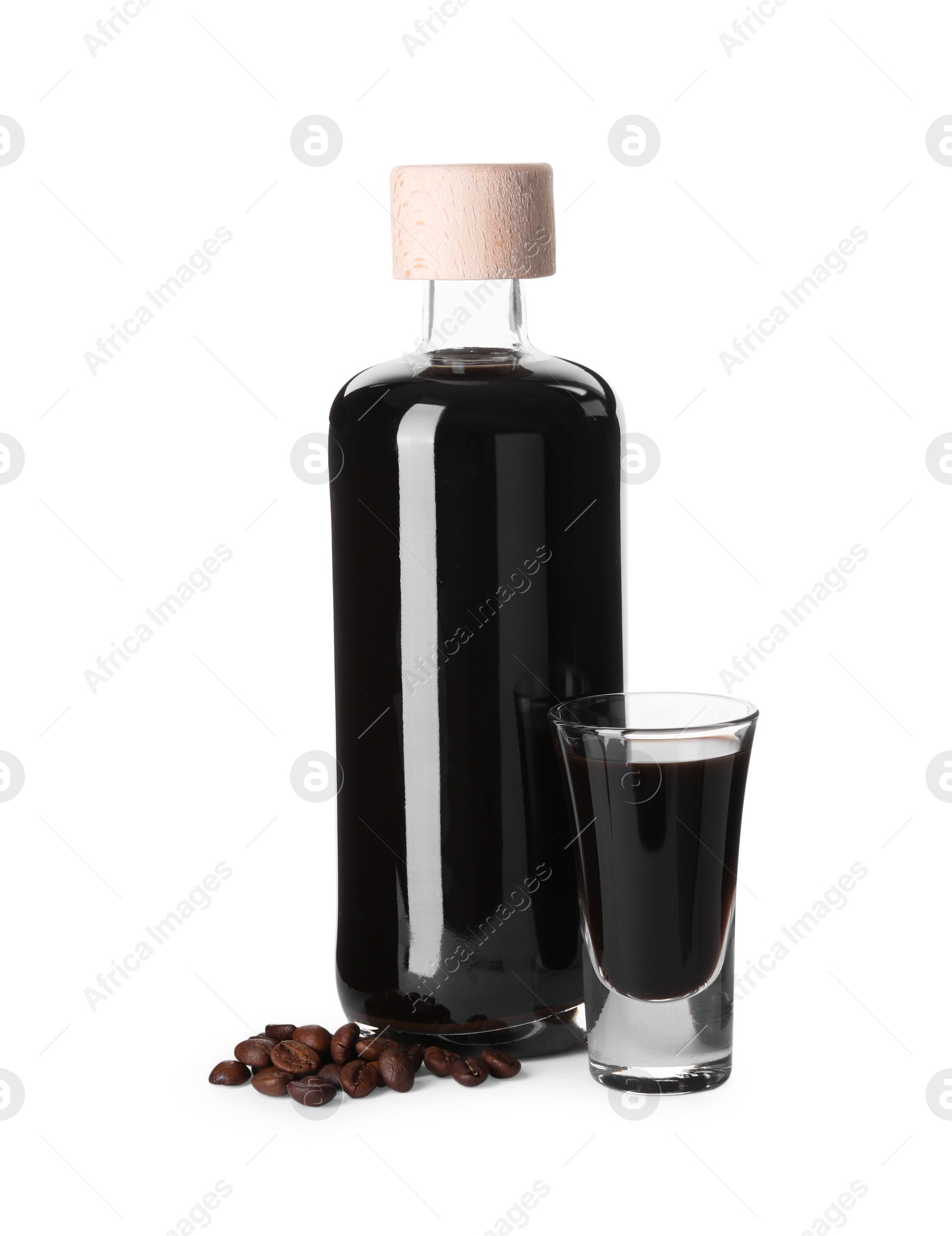 Photo of Glassware with coffee liqueur and beans isolated on white