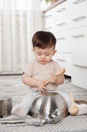 Photo of Cute little boy with cookware at home